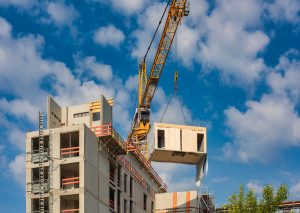 Construction site of an office building in Berlin. The new structure will be built in modular timber construction. MODULAR WOODEN HOUSES made out of renewable resources.