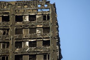 London, UK - July 5, 2017: Part of the top floors of the Grenfell Tower block of council flats in which at least 80 people are thought to have been killed following a fire in Kensington, West London.