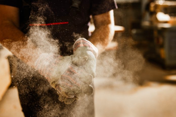 Image of worker showing wood dust management