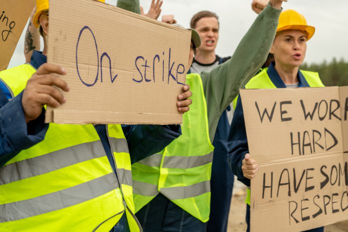 Group of angry builders with placards are on strike