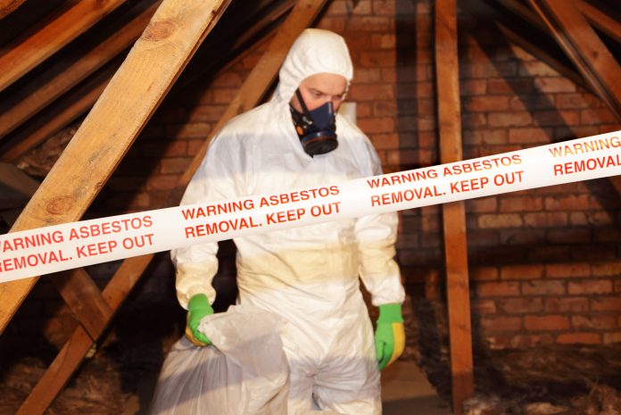 Worker clearing asbestos - asbestos exposure