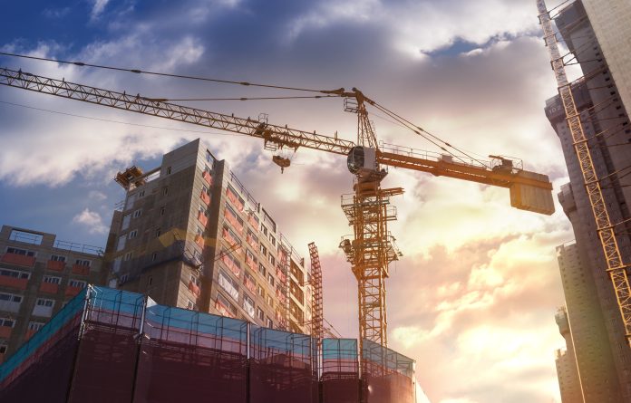 Crane in construction - UK companies announce new construction management roles