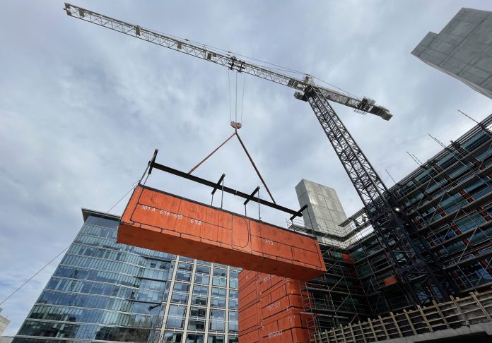 crane placing modular building into place