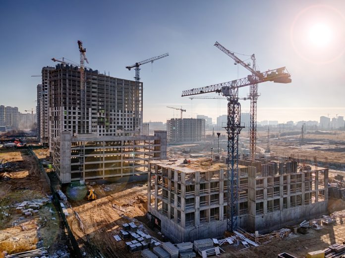 Price fluctuations, represented by a Construction site with cranes, future residential high rises