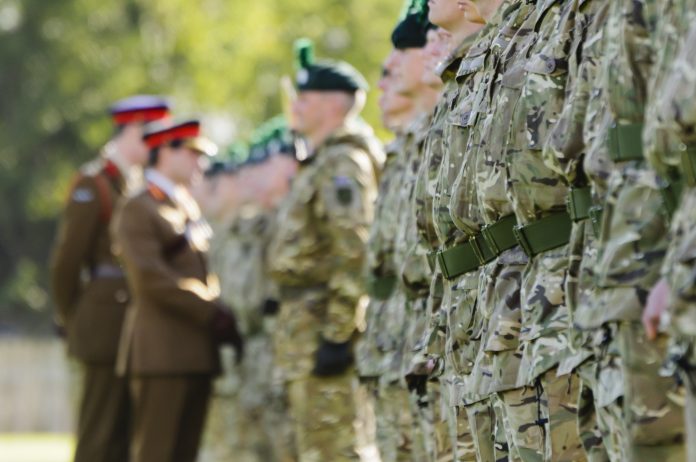 "Belfast, UK - October 7, 2011: Two army generals inspect a line of British soldiers from the Irish Guards and Royal Irish Regiment during a homecoming parade" representing MoD Strategic Alliance Contract