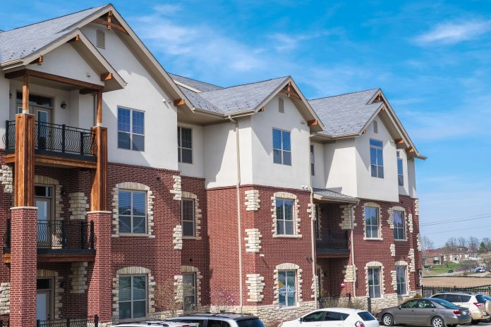 Multifamily building in a Midwestern town, USA; parked cars by the building