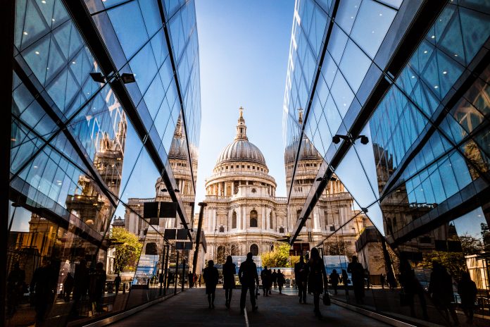 City of London gives green light for public square revamp Color image depicting a crowd of people, thrown into silhouette and therefore unrecognisable, walking alongside modern futuristic architecture of glass and steel. In the distance we can see the ancient and iconic dome of St Paul's cathedral. Room for copy space.