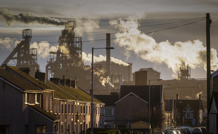 Port Talbot Steel works Editorial PORT TALBOT, UK - JANUARY 04, 2020: The houses of Port Talbot and the emissions of the TATA Steel works that provides employment for the townsfolk. Image represents Climate Change Committee report findings on net zero transition