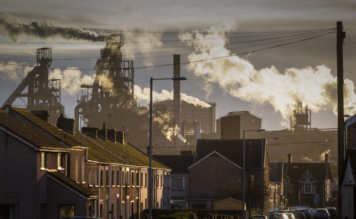 Editorial PORT TALBOT, UK - JANUARY 04, 2020: The houses of Port Talbot and the emissions of the TATA Steel works that provides employment for the townsfolk. Image represents Climate Change Committee report findings on net zero transition