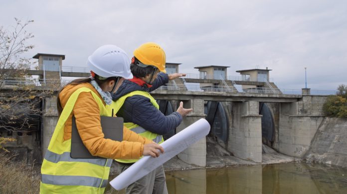 Working day on a hydroelectric power plant. Checking the condition of the equipment, and planning reconstruction of the dam wall.