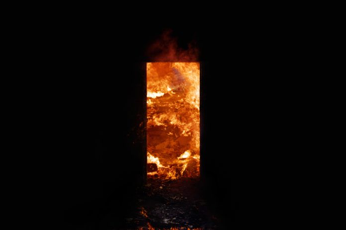 Dark Doorway of Fire, representing the risks of not observing fire door safety and compliance