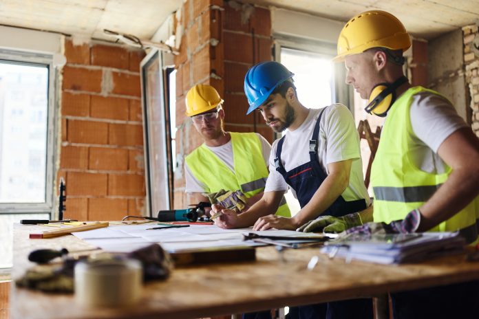 Construction workers planning - Part L Building Regulations