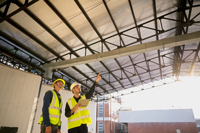 Civil Engineer and Construction Supervisor inspect the internal construction of building at construction site. Construction engineers or architect and Foreman inspect the construction inside building, representing ICW Building Control securing the ISO 9001 certification