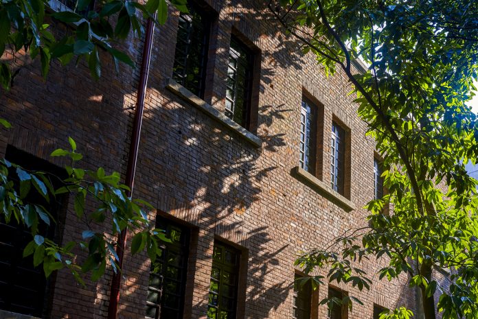 Old-fashioned red-brick houses in the woods to represent energy efficiency regulation