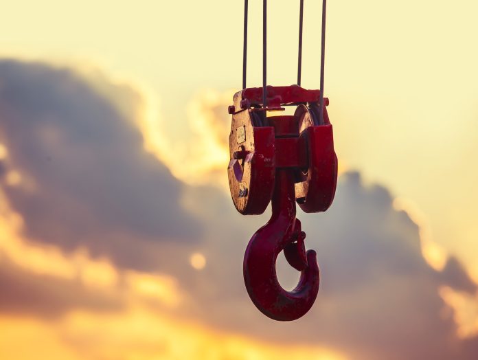 Stronger planning and project controls called for in Turner & Townsend’s UKMI report crane hook hanging in the air at sunset