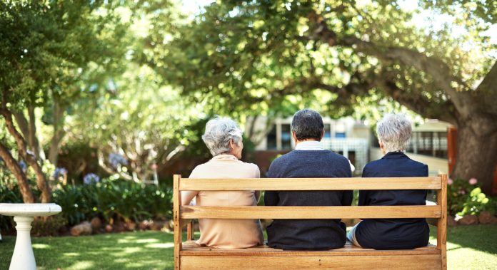 Inspired Villages acquires 27 acre site for Edenbridge retirement community Rearview shot of a group of seniors sitting together on a bench out in the garden