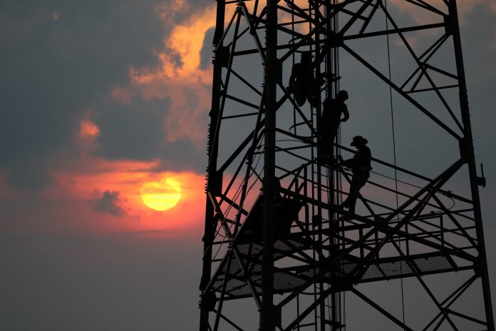 Specialist supplier Adastra Access falls into administration Workers are climbing to repair the telecommunication tower or poles, in the evening to represent Adastra Acess falling into administration