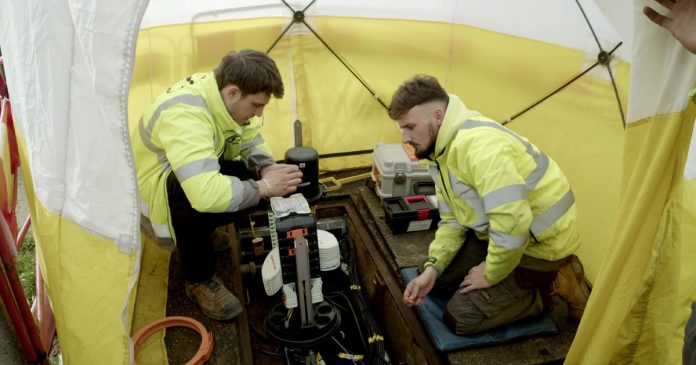 two construction workers using field management software