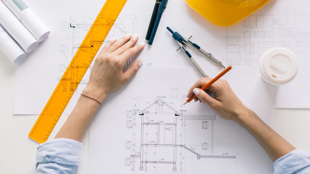 Architect drawing blueprints, architectural project in progress. Construction engineering