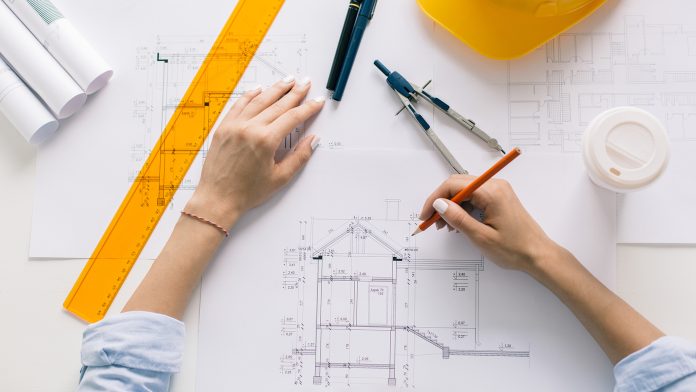 Empowering women in construction: Afsheen Ul Haq’s journey as a forensic and risk planning manager Architect drawing blueprints, architectural project in progress. Construction engineering