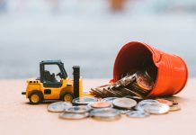 How beneficial have regulations been in building a responsible construction payment culture? Closeup stack coins with construction vehicle using as business, industrial and financial concept