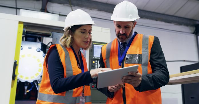 Shot of two engineers using a digital tablet together in an industrial place of work, representing Asta Powerproject