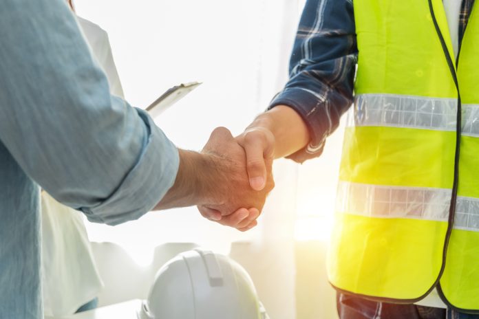 Viewpoint and Sypro Contract Manager collaborate to promote compliance on construction contracts Contractor. construction worker team hands shaking after plan project contract on workplace desk in meeting room office at construction site, contractor, engineering, partnership, construction concept