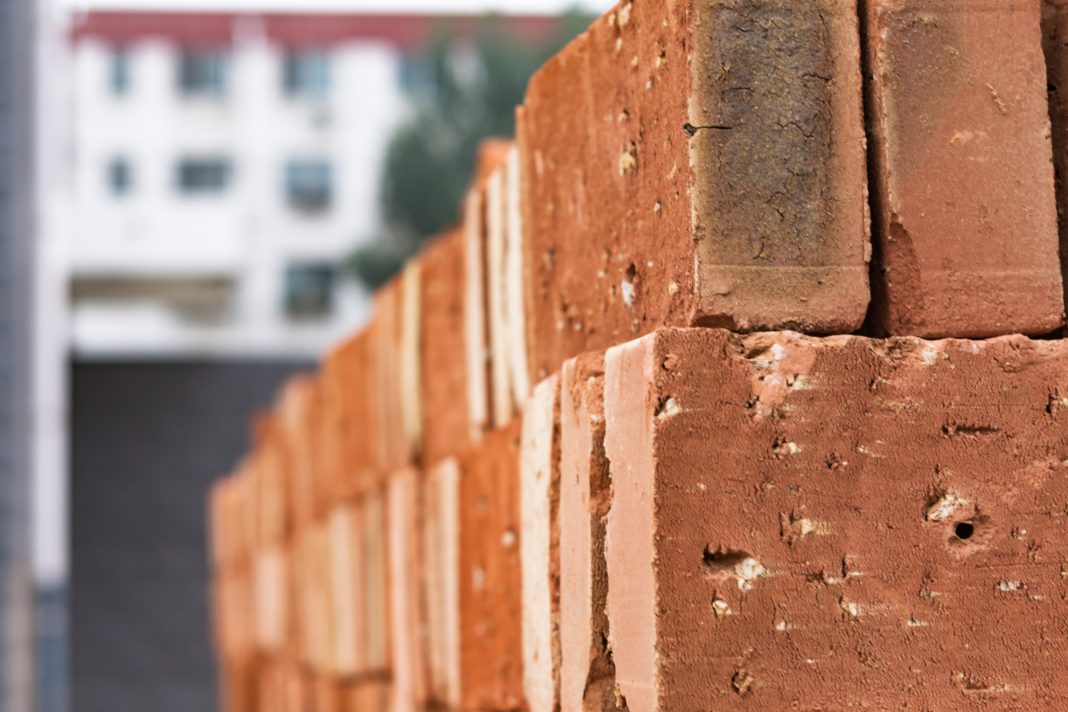 Huge pile of red-brown bricks, orange bricks, representing British brickmaker Forterra