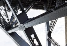 Frame by frame: The drive to implement steel reuse in construction Low angle view of steel structure and beams under Harbour bridge Sydney Australia, full frame horizontal composition