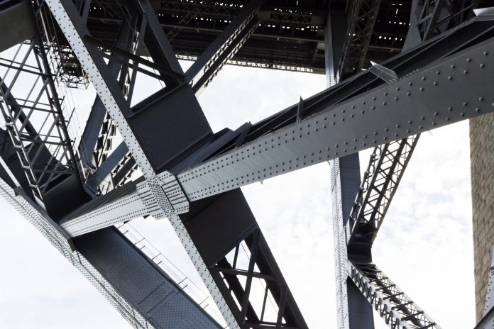 Frame by frame: The drive to implement steel reuse in construction Low angle view of steel structure and beams under Harbour bridge Sydney Australia, full frame horizontal composition