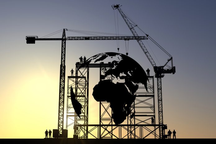 Global demand for UK construction exports and expertise could generate £11.5bn Globe icon construction site silhouette with cranes and steel structures, representing potential UK construction exports