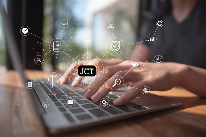 person typing on a laptop with the jct logo