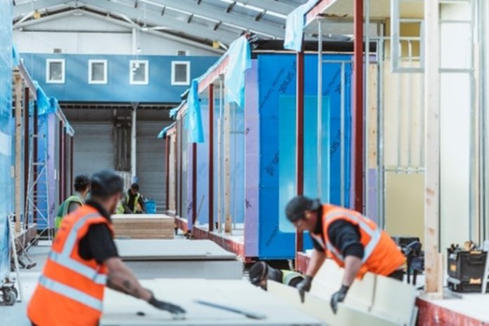 Inside the Premier Modular factory Image of two workers at modular construction factory