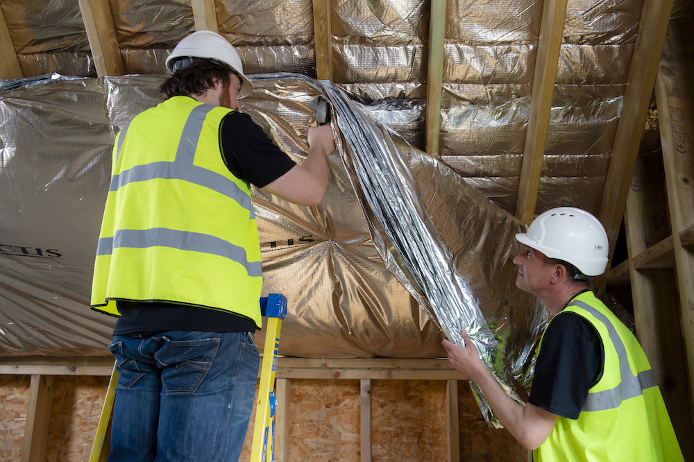 image of two workers installing insulation in loft