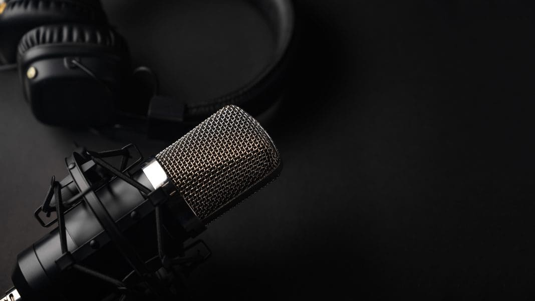 Studio black studio microphone with studio headphones on a black SFS podcast episodes cover fragile roof design trends, U-Values, the Construction Playbook and much more