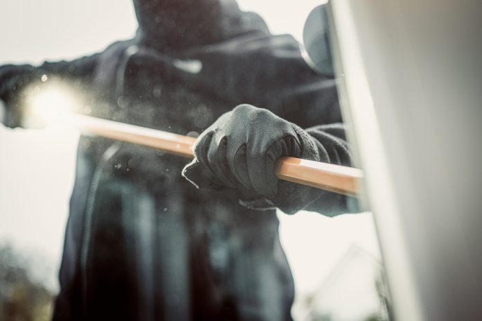 Burglary breaking into family home with a crowbar, representing tool theft