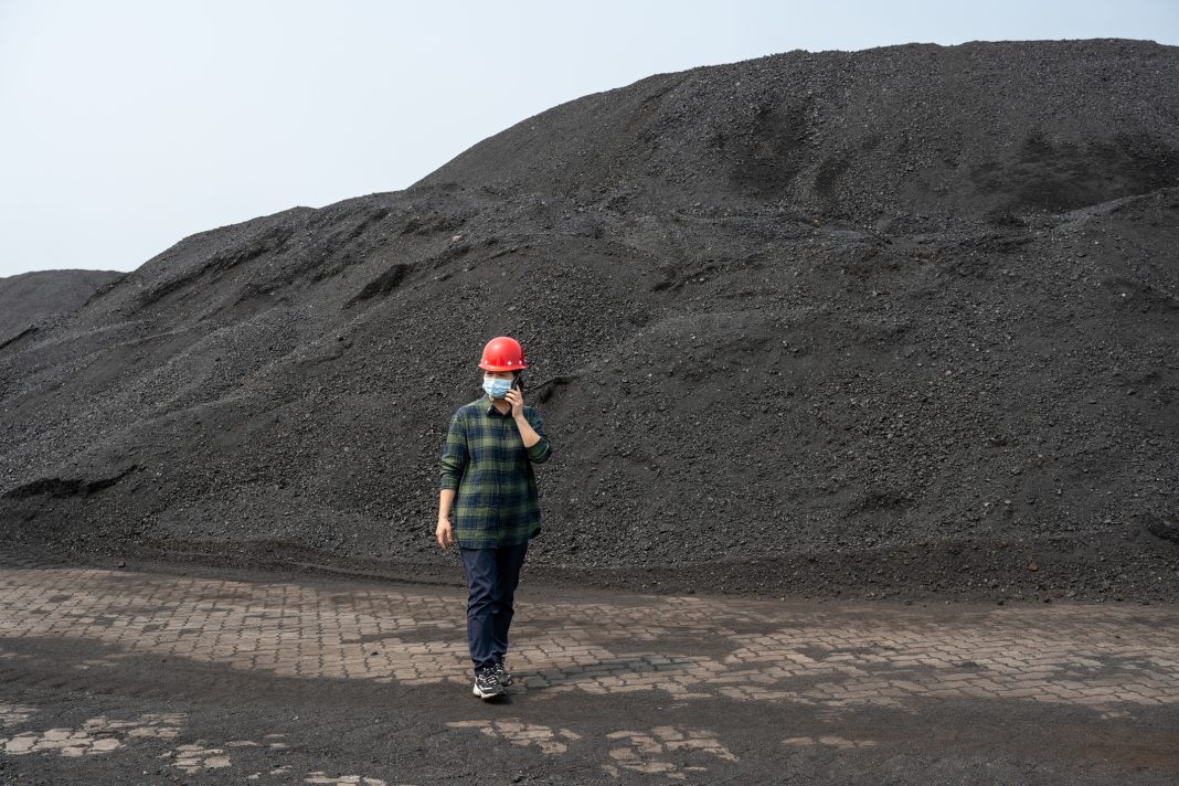 A female technician is working at a coal terminal Matthew Jones, founder of Open ECX, explores why carbon reporting and digital systems will be key to driving a net zero future
