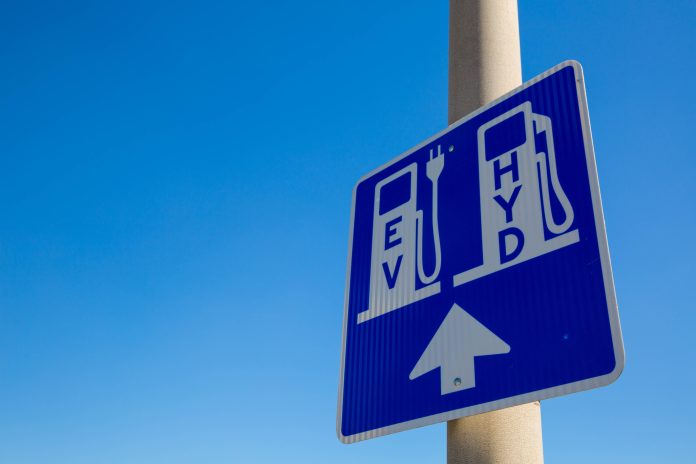 Electric Vehicle and Hydrogen Fueling Charging Station Renewable A sign for EV and HYD cars to charge and fuel, representing the hydrogen fuel retrofit project