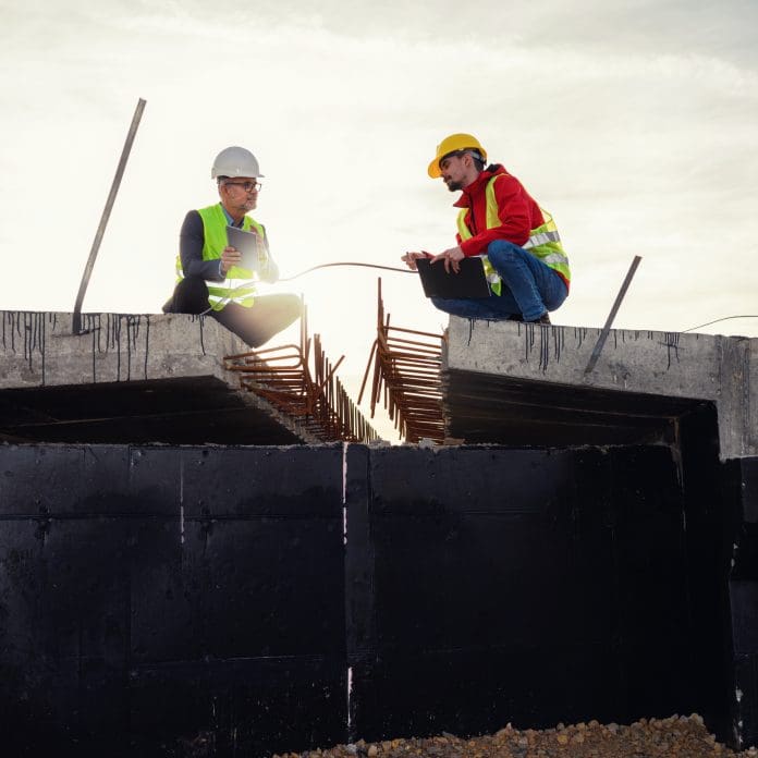 construction output - two construction workers