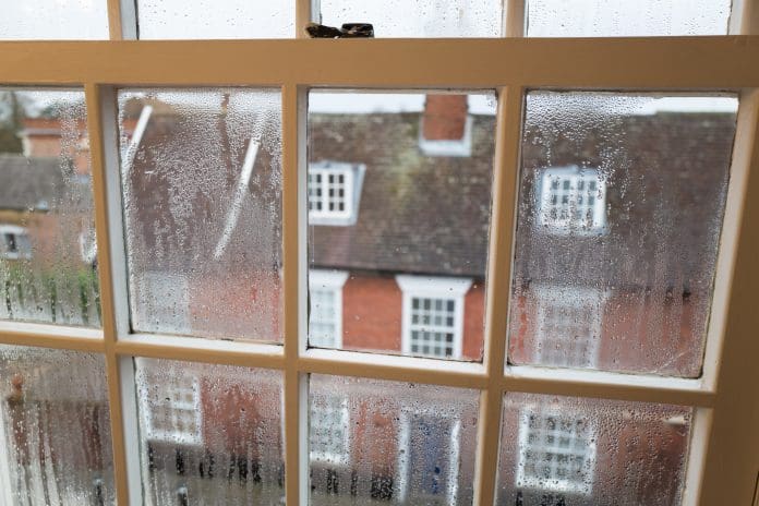 Condensation. Condensation on a sash window overlooking a street in Bury St Edmunds in Suffolk England UK , representing Selectaglaze's guide to secondary glazing