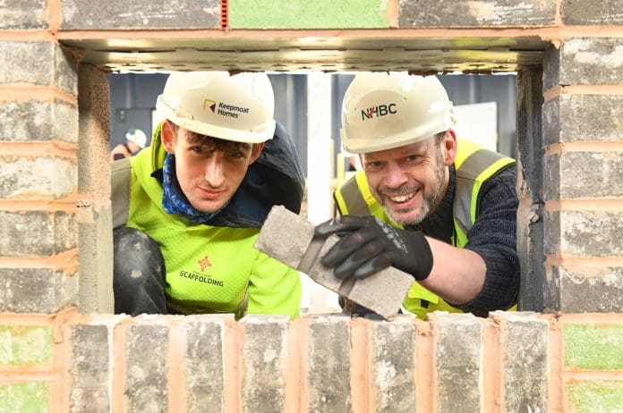 Mayor Jamie Driscoll learns bricklaying skills from Cain Richardson, apprentice at the NHBC Newcastle Training Hub