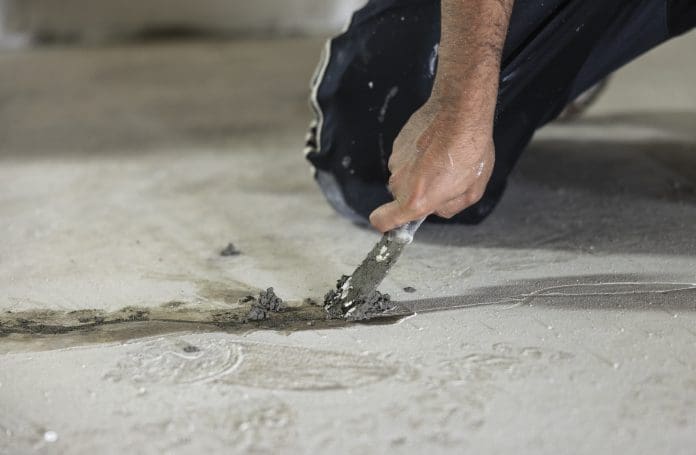 Hydraulic cement used for sealing cracks in the floor to waterproof the basement.
