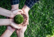 Carbon roadmapping: Defining the action plan for delivering net zero to built asset portfolios Top View Hands of People Embracing a Handmade Globe for Protecting Planet Together in World Earth Day Concept. Green Energy, ESG, Renewable, and Sustainable Resources. Environmental Care.