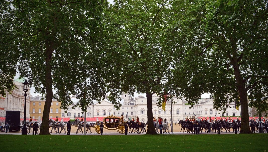 Royal Carriages London,UK -June 4th 2014: A royal carriage procession with mounted guards returns from the State Opening of Parliament ceremony and here crosses Horse Guards Parade in London, representing the King's Speech