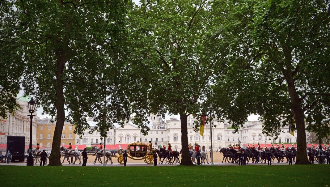 London,UK -June 4th 2014: A royal carriage procession with mounted guards returns from the State Opening of Parliament ceremony and here crosses Horse Guards Parade in London, representing the King's Speech