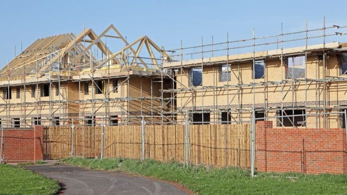 Construction contract awards down 14% in 2023 Image of houses under construction