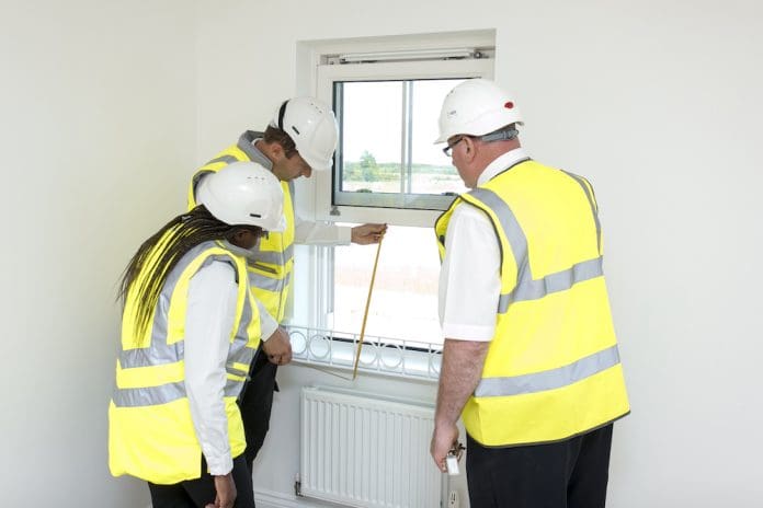 Builders checking the compliance of a home