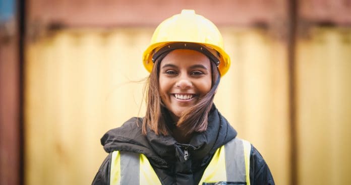 Shot of a young woman wearing a hardhat at work