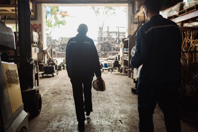 Mental health and wellbeing - A pair of Asian factory coworkers stepping out for a rest