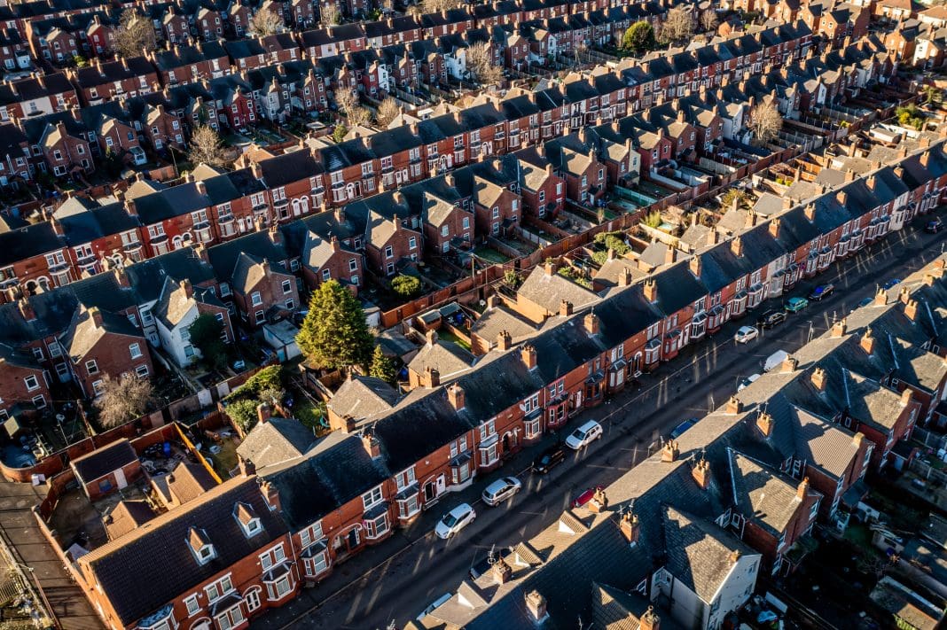 An aerial view of rows of back to back terraced houses in a working class area of a Northern town in England, representing the housing infrastructure fund